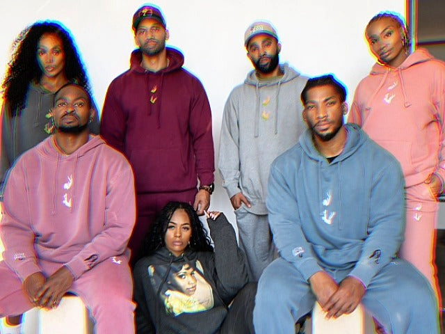 Five friends in Adam & Eavesdropping tracksuits in maroon, grey, blue and pink